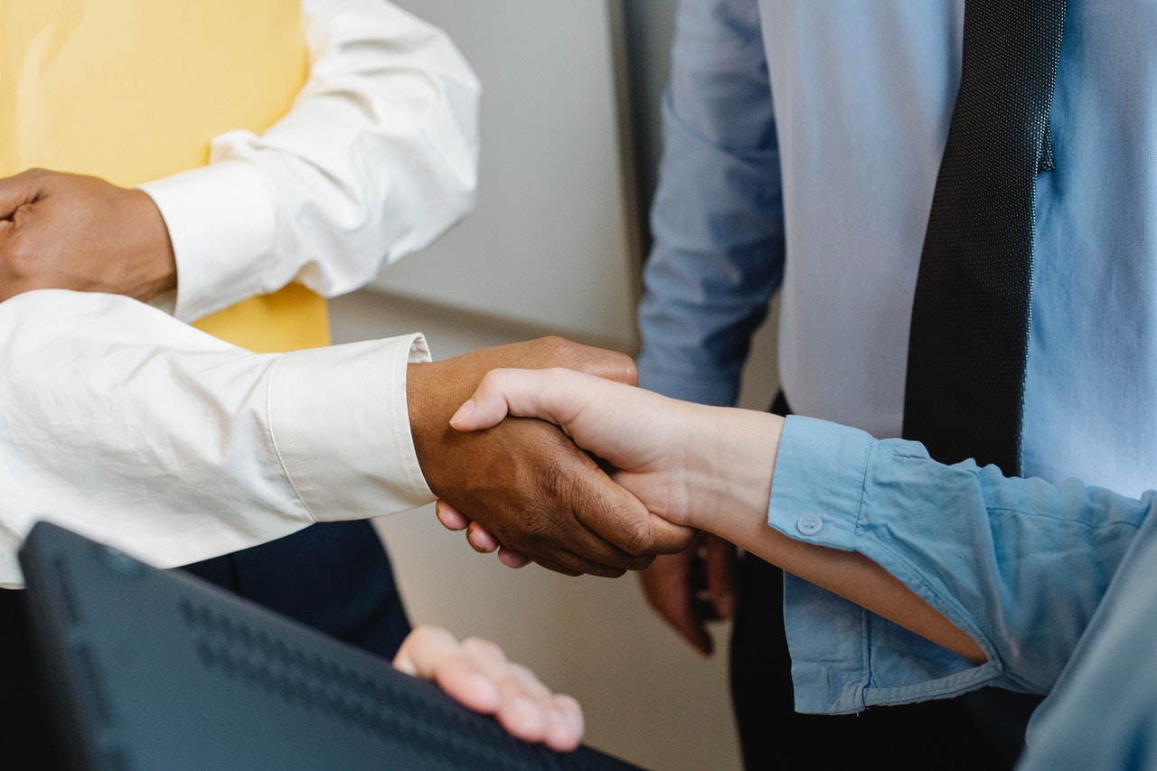 Sales agent at insurance agency receiving training and closing a deal