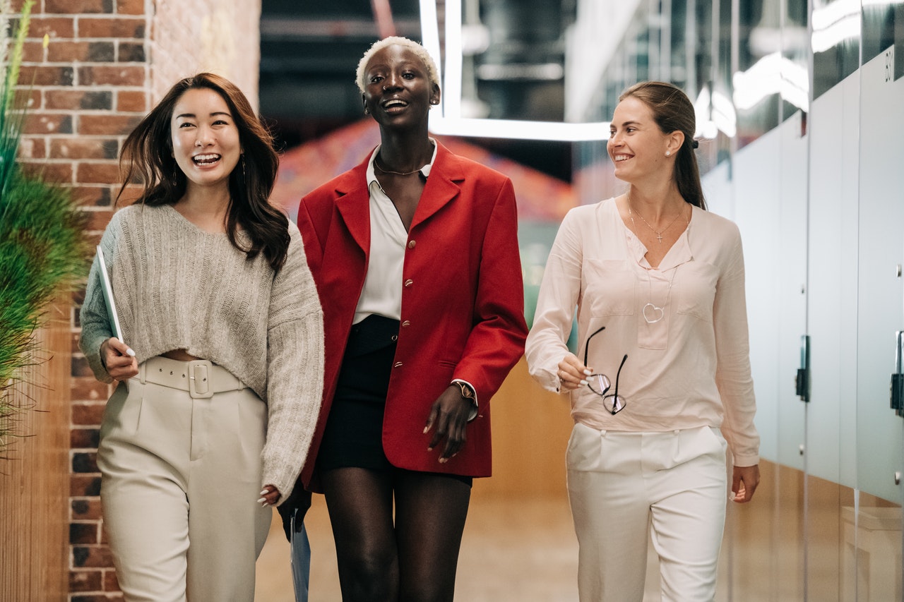 Three insurance agents walking down a hallway in their flexible schedule office