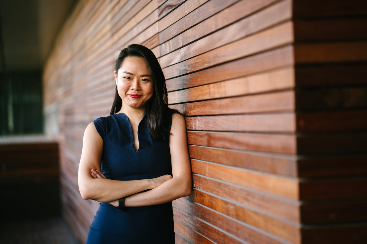 Insurance producer leaning on wooden wall