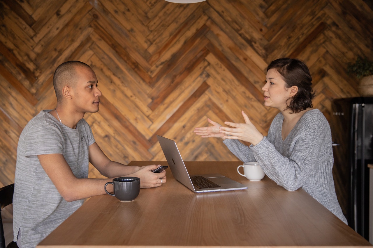 Manager talking to employee about hygiene problems