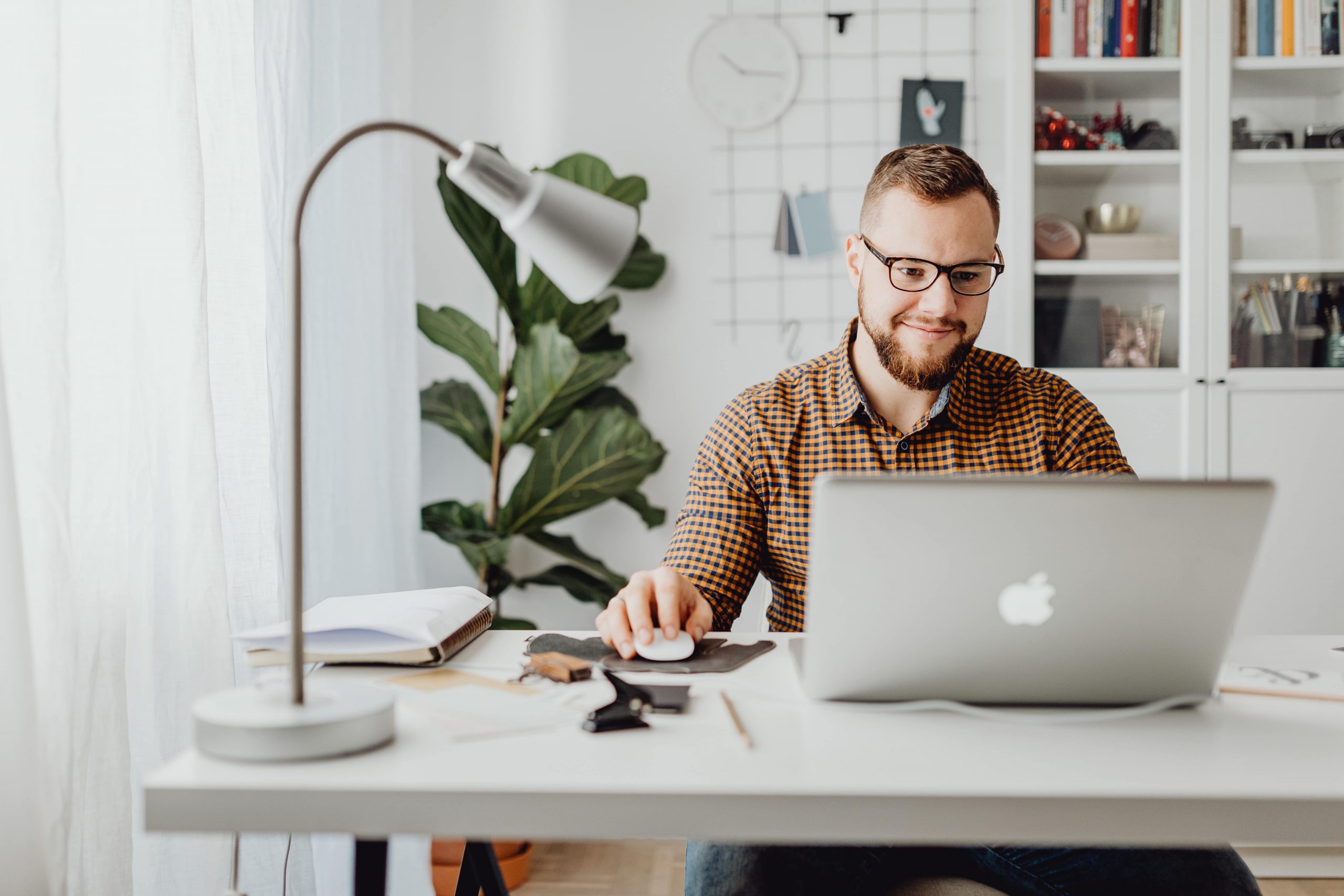 Man in glasses working in home office after taking break from insurance industry