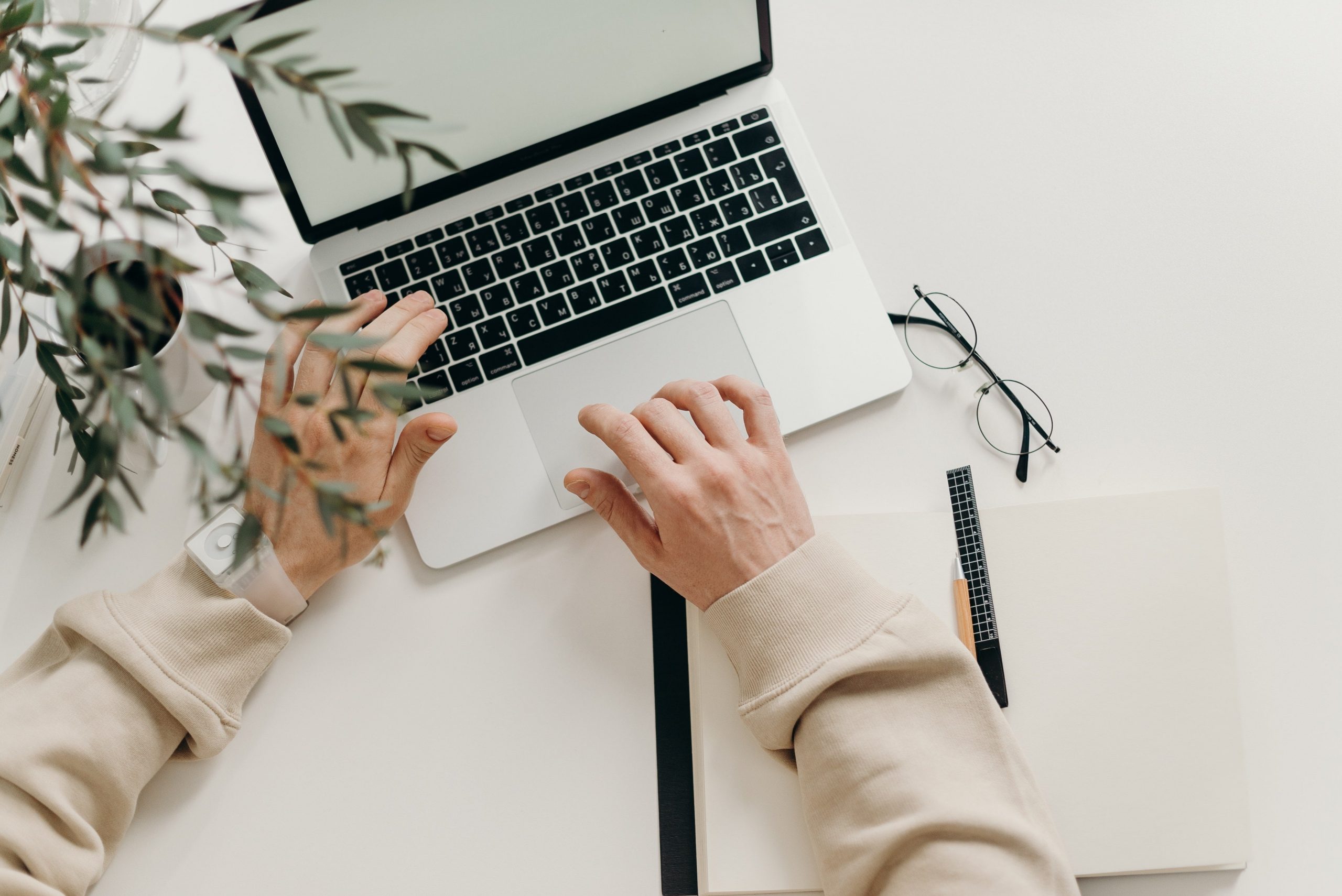 Marketing professional working on insurance agency project on laptop
