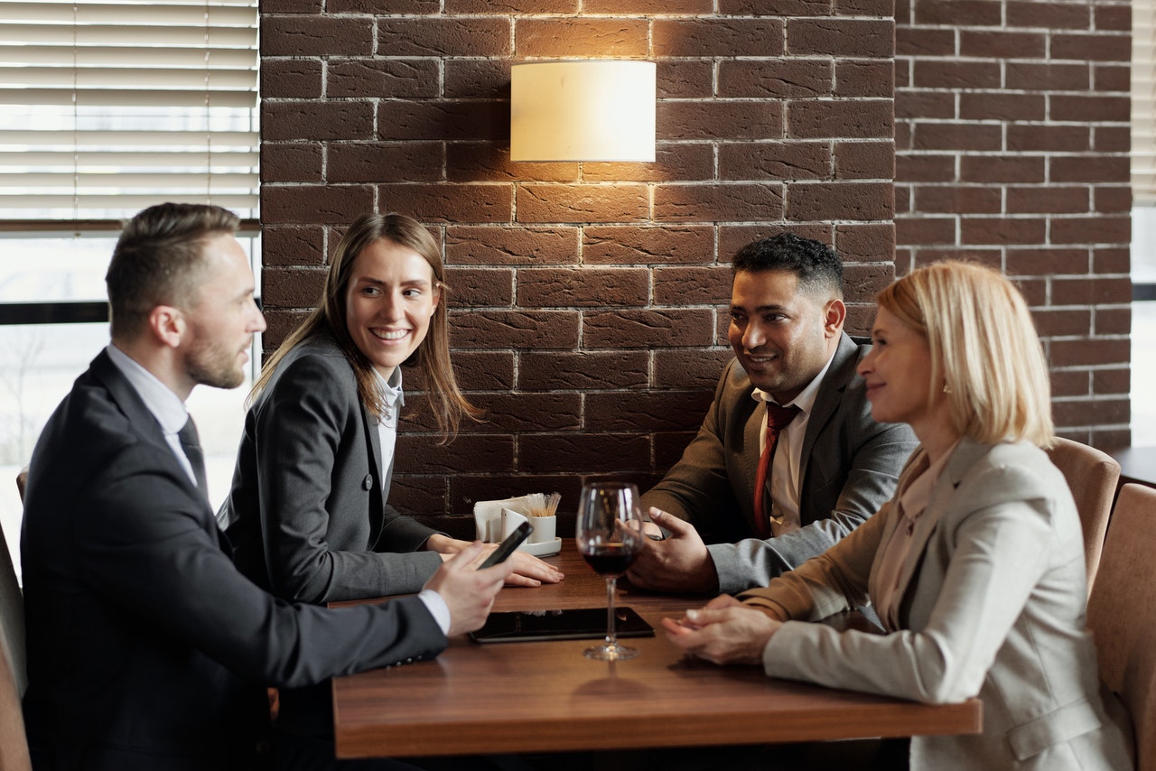 Group of Coworkers gossiping at a cafe during lunch