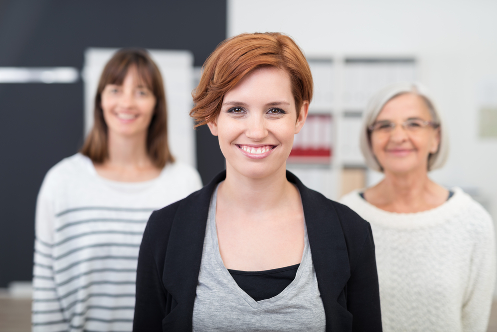 Third generation agency worker standing in front of mother and grandmother