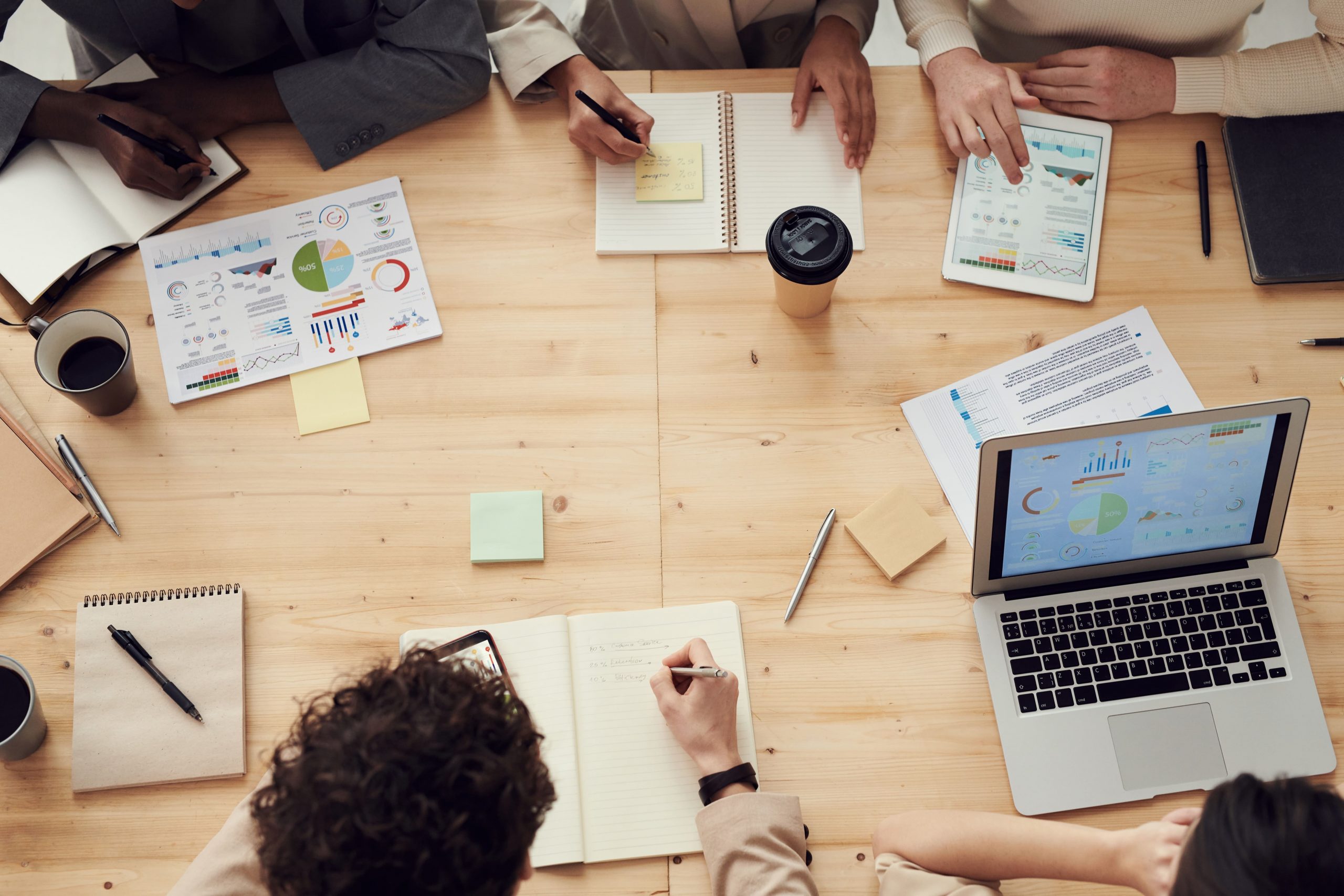 Meeting table with papers on it with financial reports