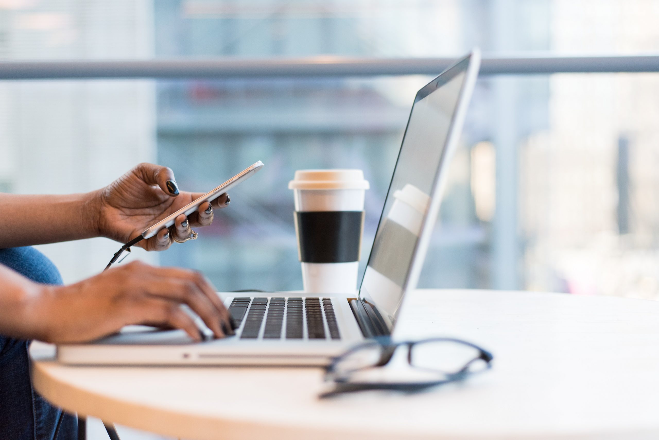 Insurance producer working on laptop and cellphone during pandemic