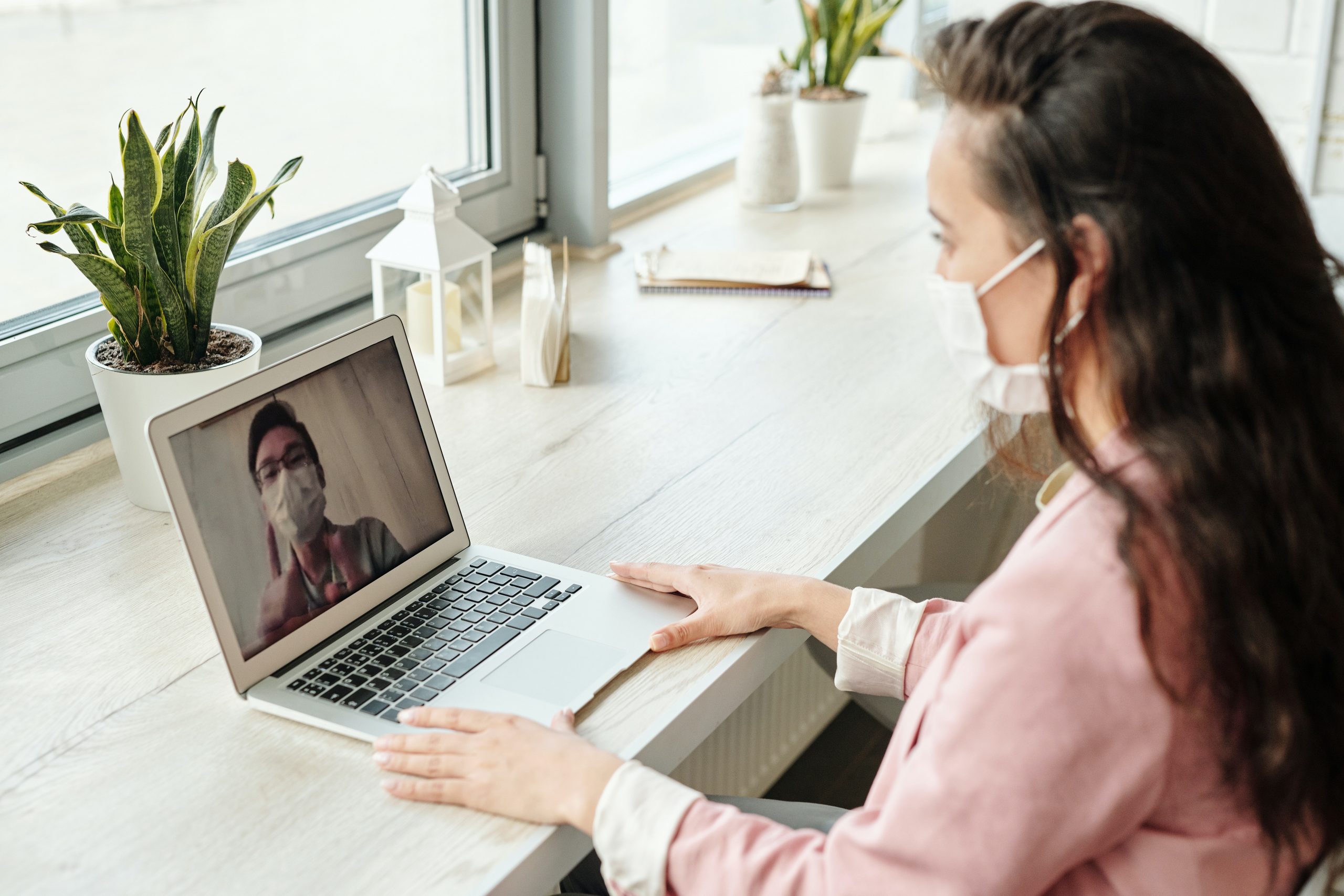 Woman wearing face covering on zoom call during pandemic