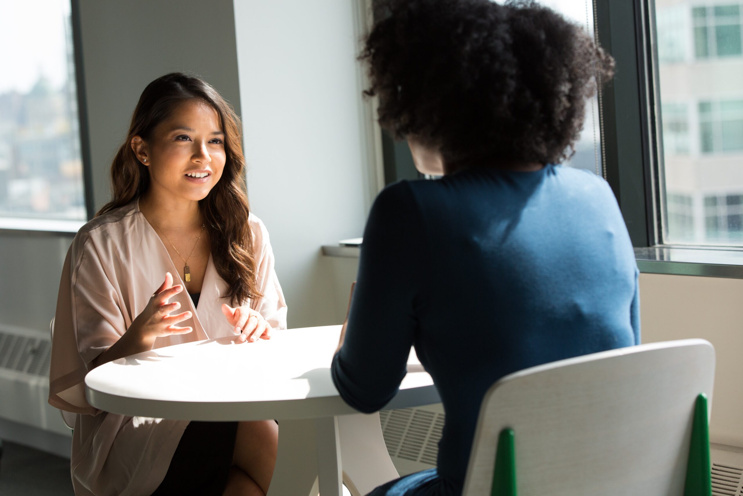 Two Hiring Managers Discussing Employee Department Transition