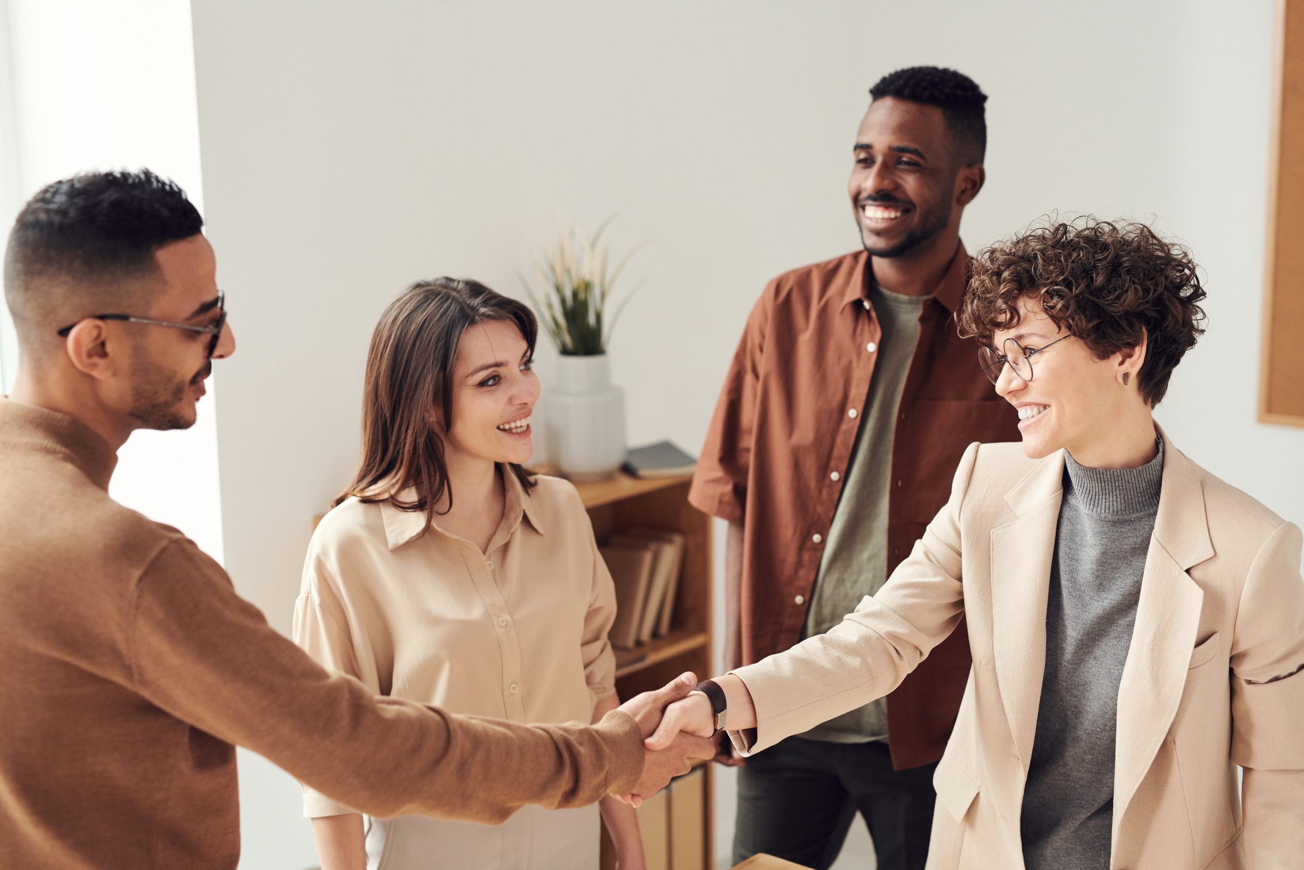men and women coworkers shaking hands