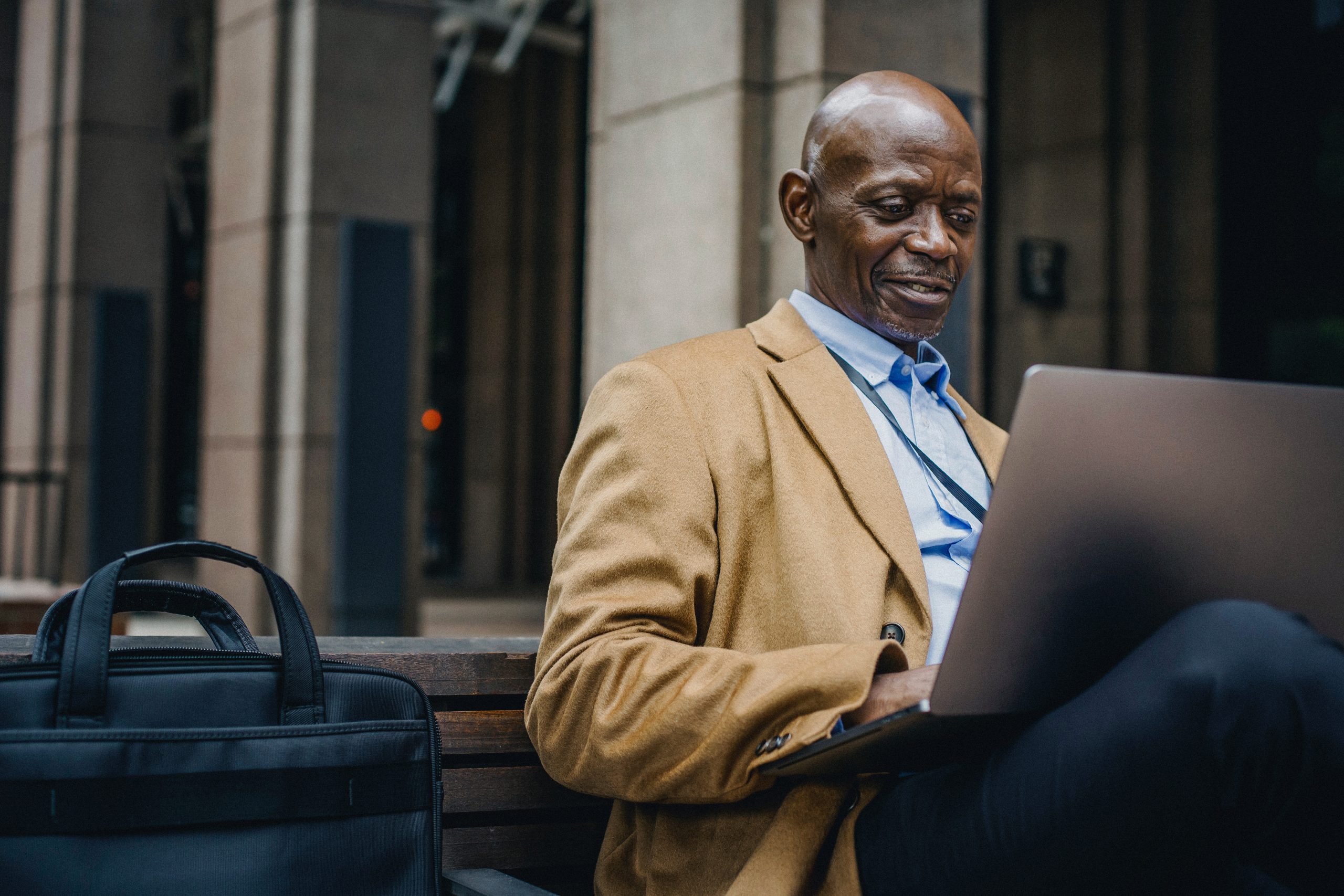 Black Insurance Producer Sitting on a Bench