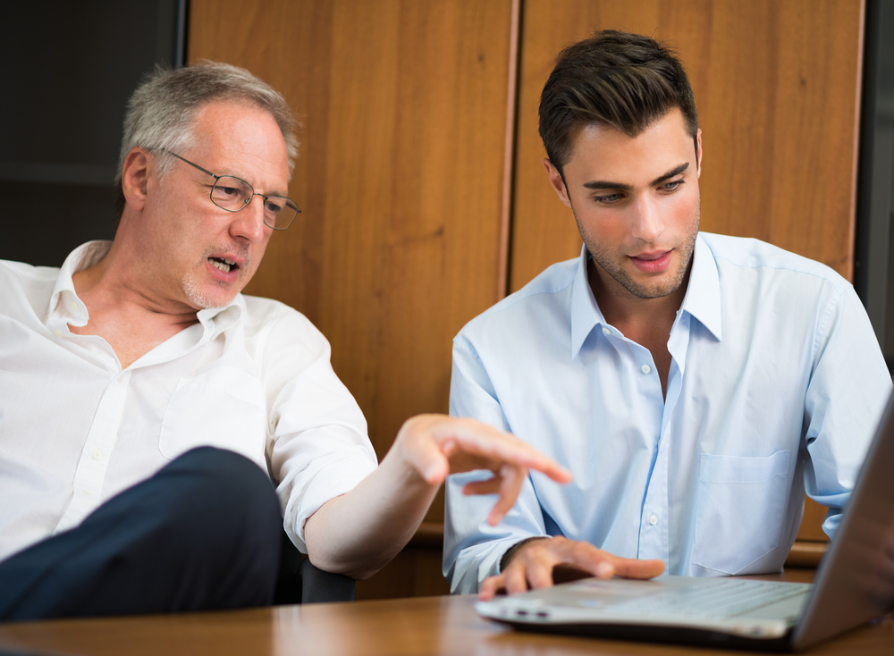 Father and Son Discussing Family Business Insurance Agency
