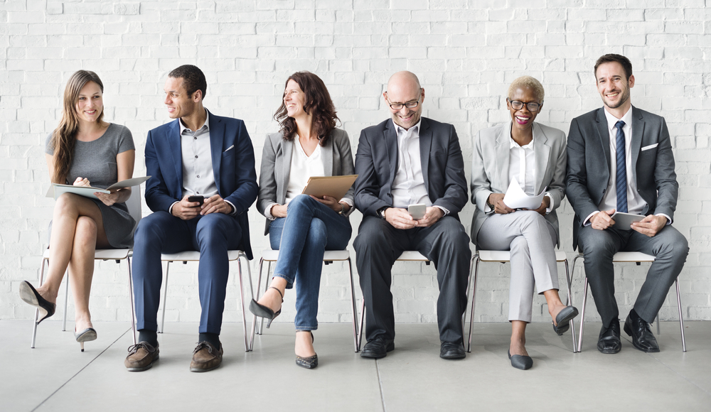 Insurance agency job candidates lined up in chairs for interview